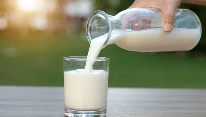 person pouring Malted milk in a glass