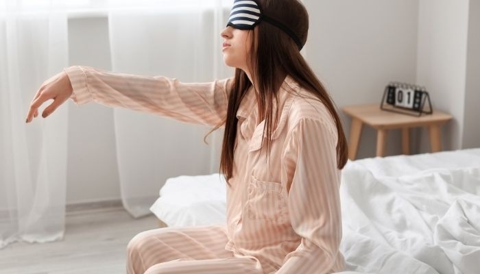 women sitting on bed wearing eye cover
rem sleep disorder