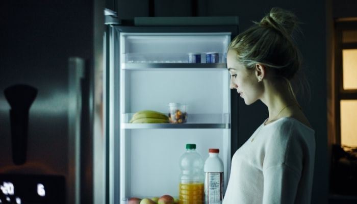 woman standing in front of a opened freeze