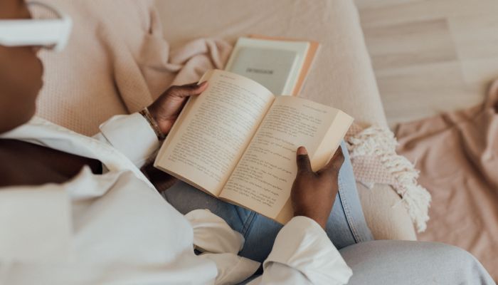 women reading book to relax during period