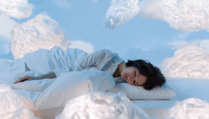 woman sleeping on bed surrounded by clouds
tips on resetting biological clocks