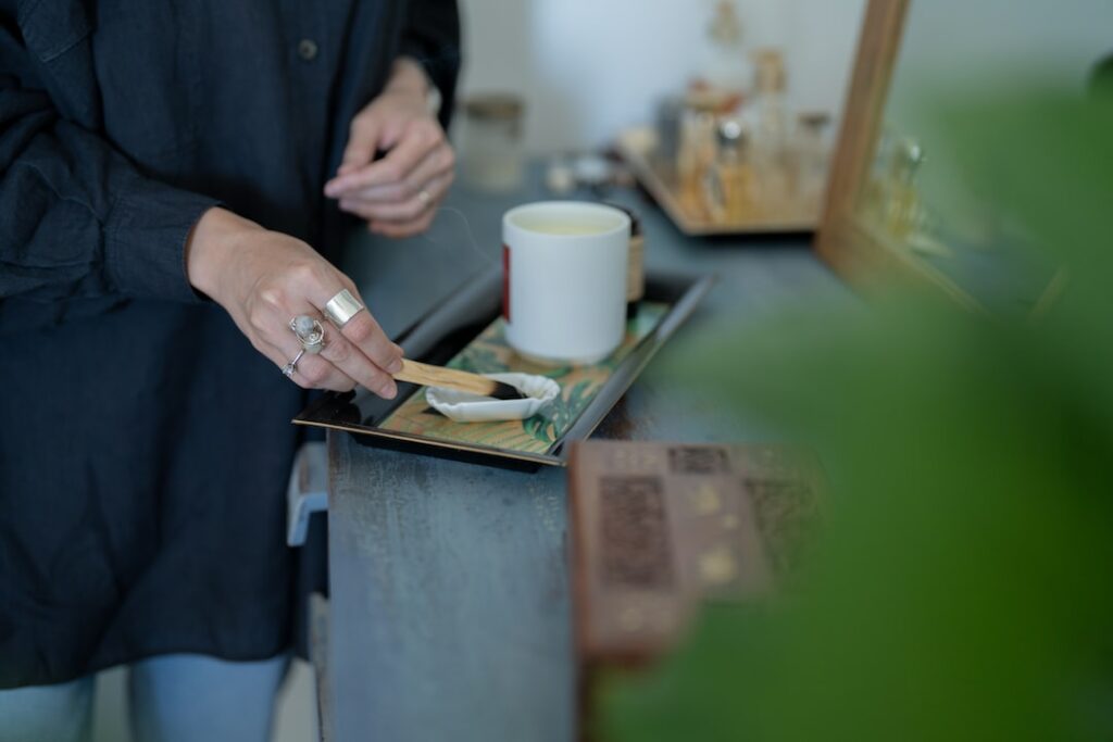 a person burning incense
