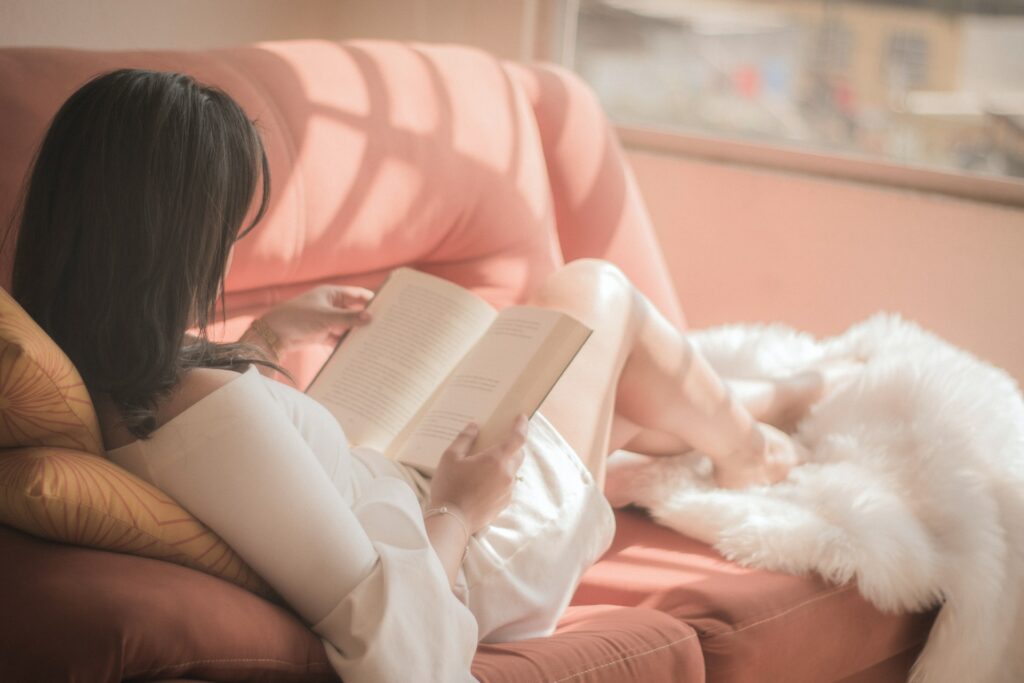 women reading book in sofa
read to sleep