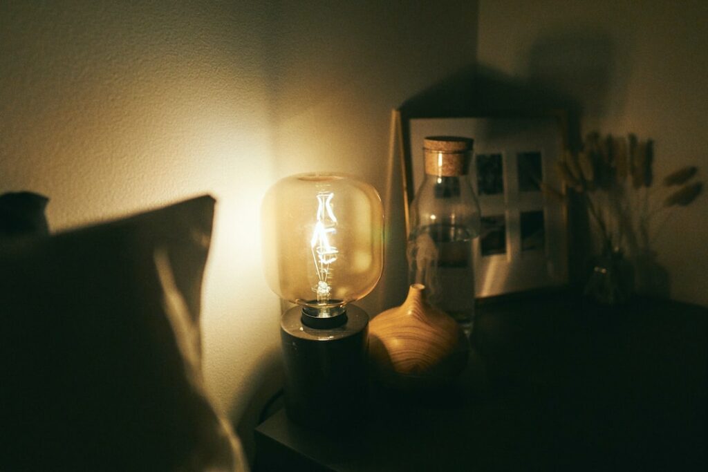 clear glass lamp on black wooden table
sleeping with lights on
