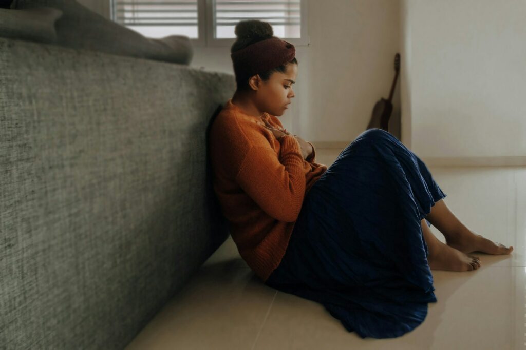 man in orange long sleeve shirt sitting on gray couch
how to sleep when anxious