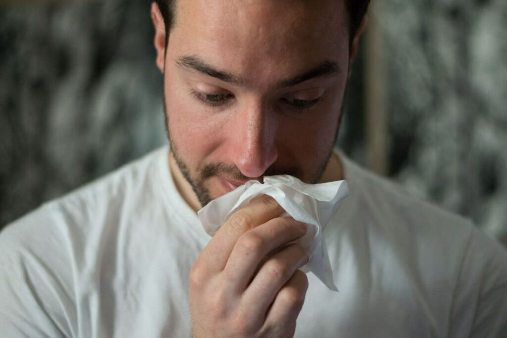 man with tissue
postnasal drip and congestion can cause morning sore throat