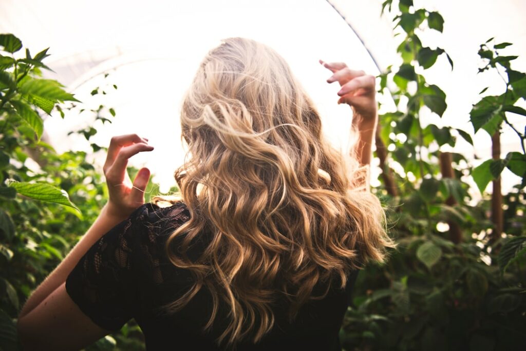 backside photo of a blonde haired woman